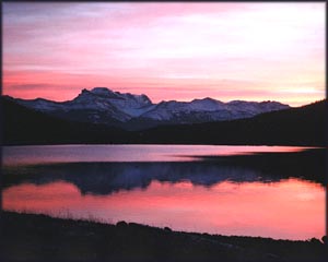 Purple sunset over mountains by the sea.