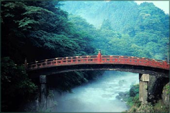 Photo of red bridge, probably Japanese bridge.